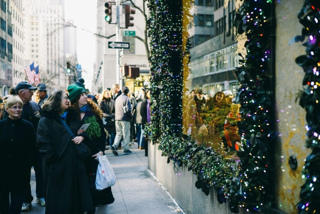 Shoppers and tourists admiring the dazzling holiday window displays along Fifth Avenue in New York City—an iconic stop on any Christmas bucket list.